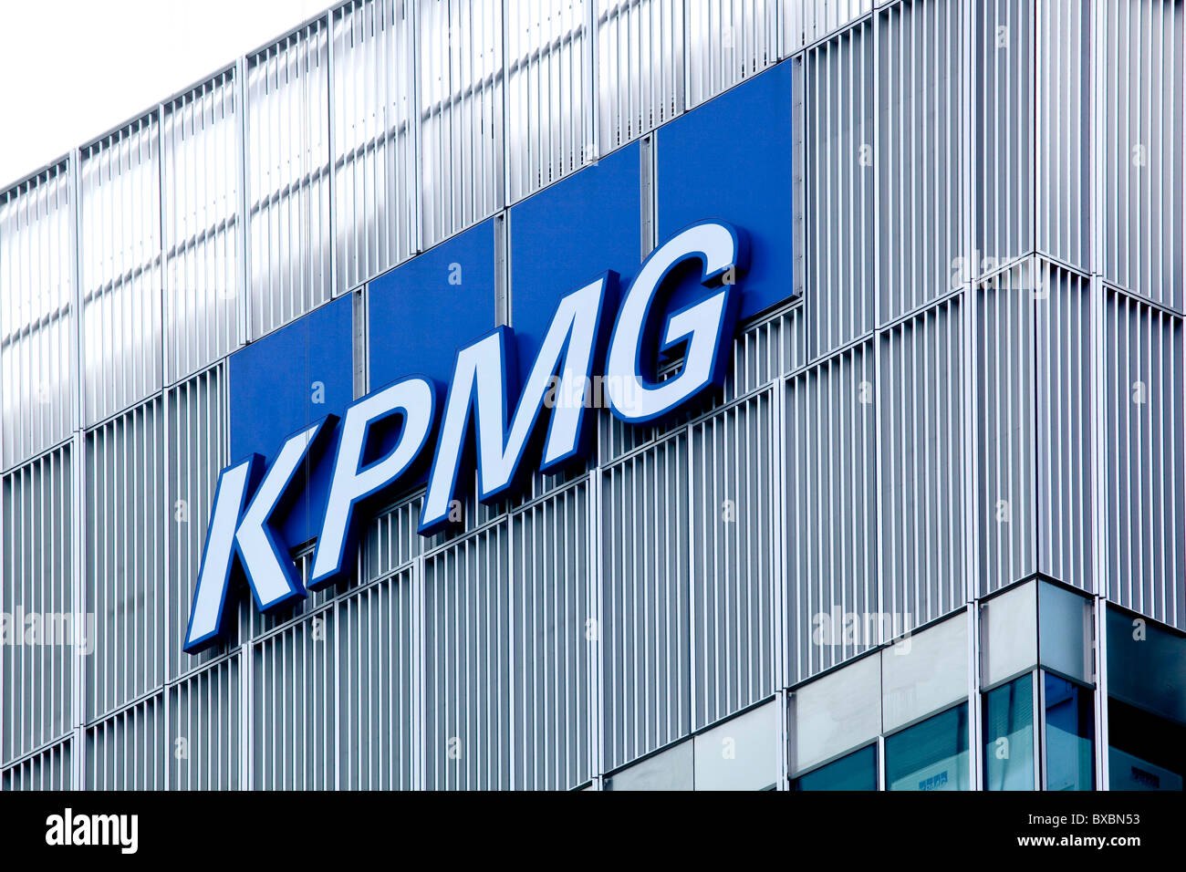 view of top of a skyscraper with KPMG sign on it